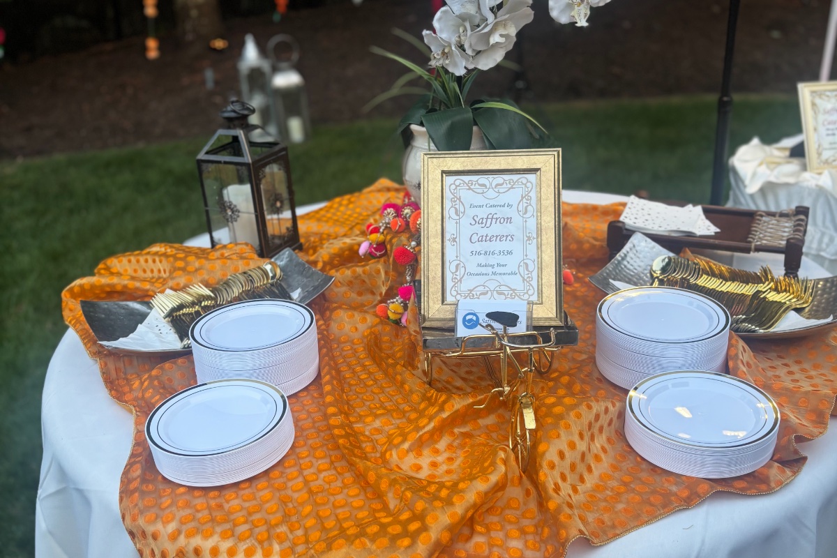Buffet table with chicken tikka masala, palak paneer, and basmati rice for catering events